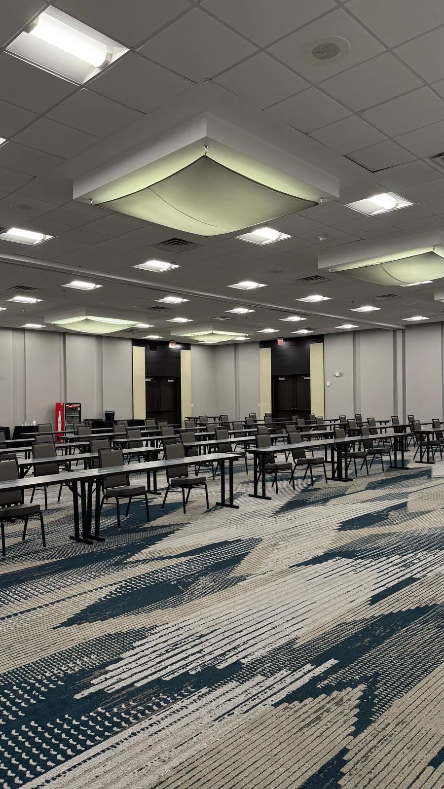 Installed ballroom wallcovering behind rows of meeting tables and chairs · Hotel Alba Tampa, Tapestry Collection by Hilton