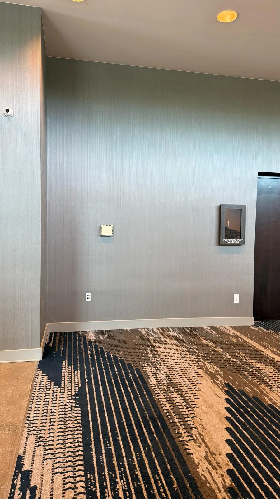 Installed wallcovering beside the doorway and base trim · Hotel Alba Tampa, Tapestry Collection by Hilton