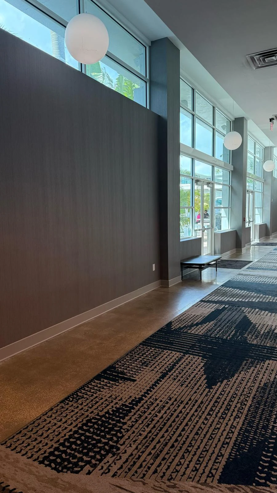 Installed textured wallcovering beside the hallway windows · Hotel Alba Tampa, Tapestry Collection by Hilton