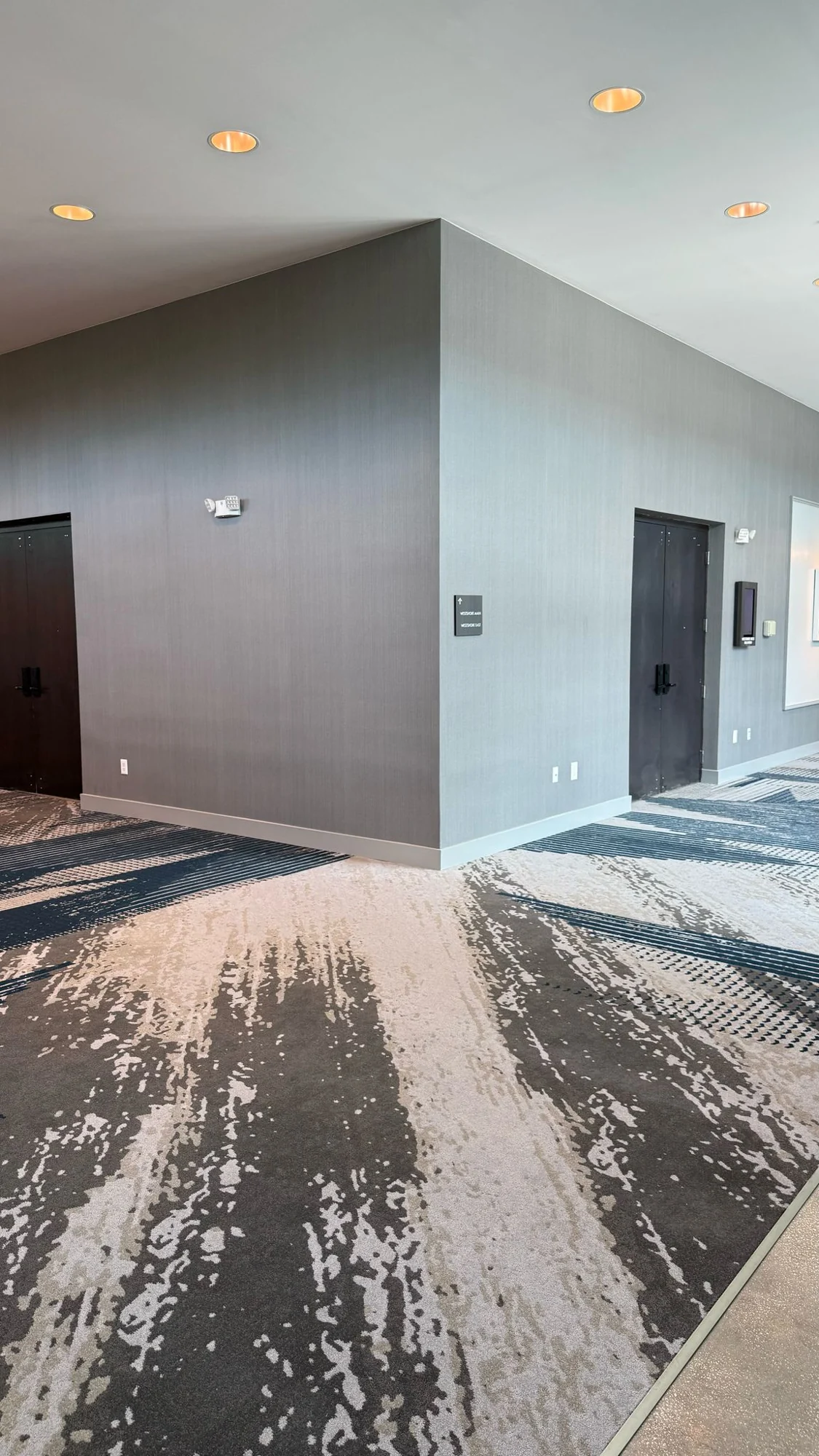Textured wallcovering around the corner between ballroom doorways · Hotel Alba Tampa, Tapestry Collection by Hilton