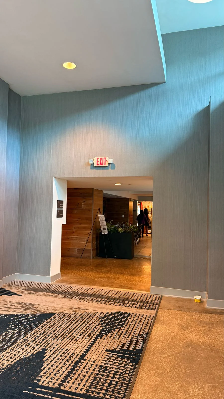 Installed textured wallcovering around the tall vestibule opening · Hotel Alba Tampa, Tapestry Collection by Hilton