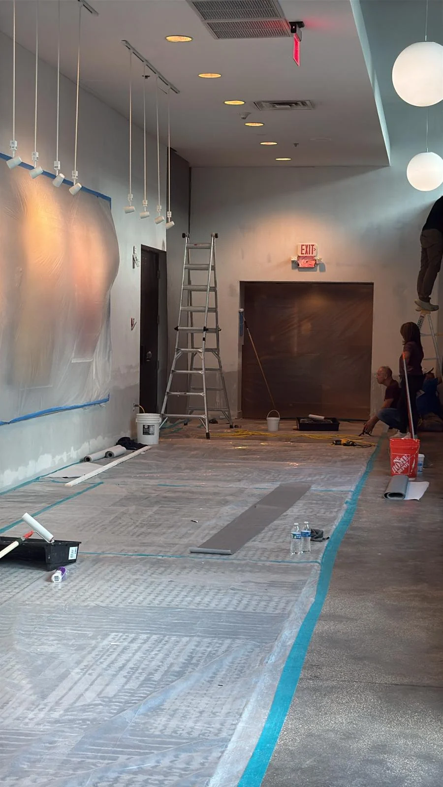Wall preparation near the entrance with artwork and existing carpet protected · Hotel Alba Tampa, Tapestry Collection by Hilton