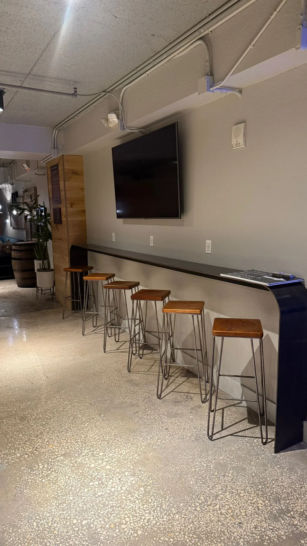 Finished TV wall and counter seating inside Buffalo Lounge