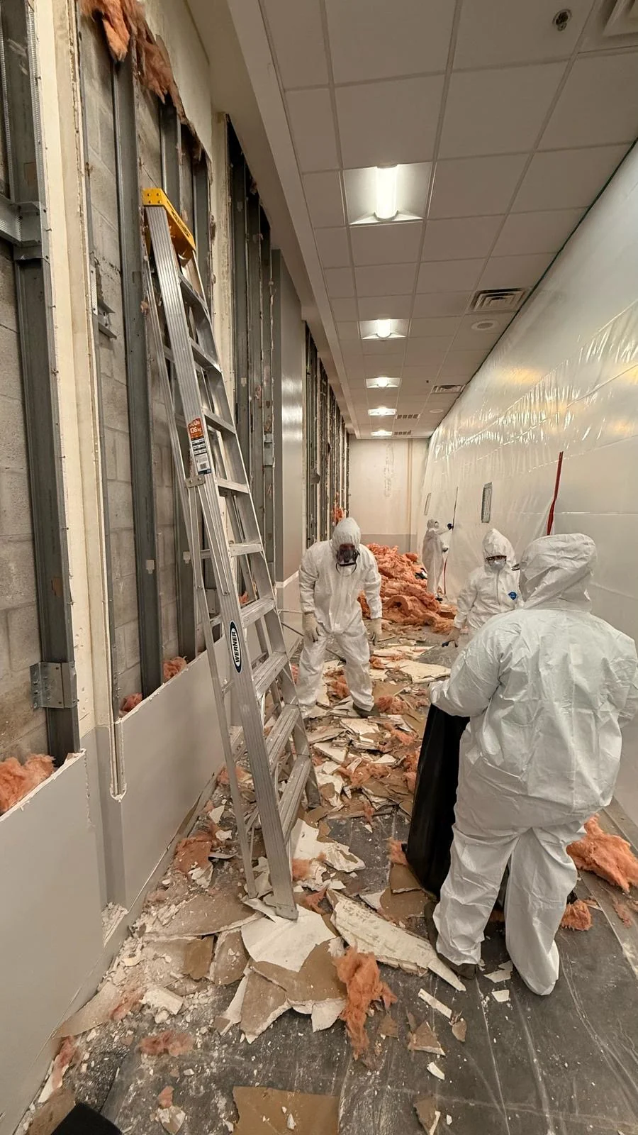 Crew bagging removed material with the floor and surrounding area protected · Tapestry Collection by Hilton