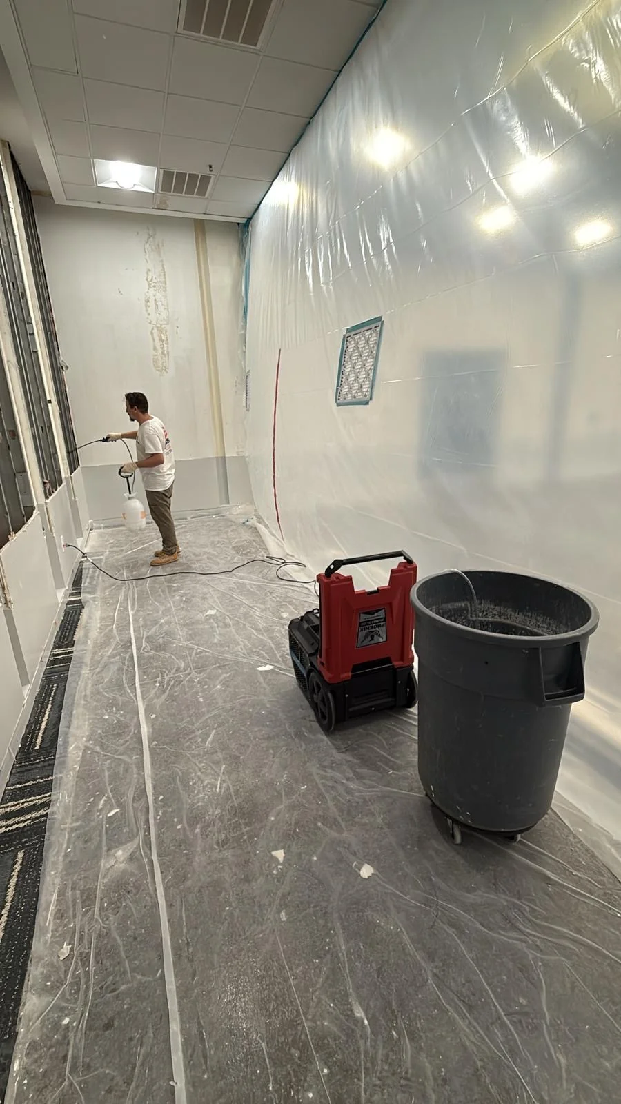 Work equipment and a collection bin inside the plastic-sheeted enclosure · Tapestry Collection by Hilton