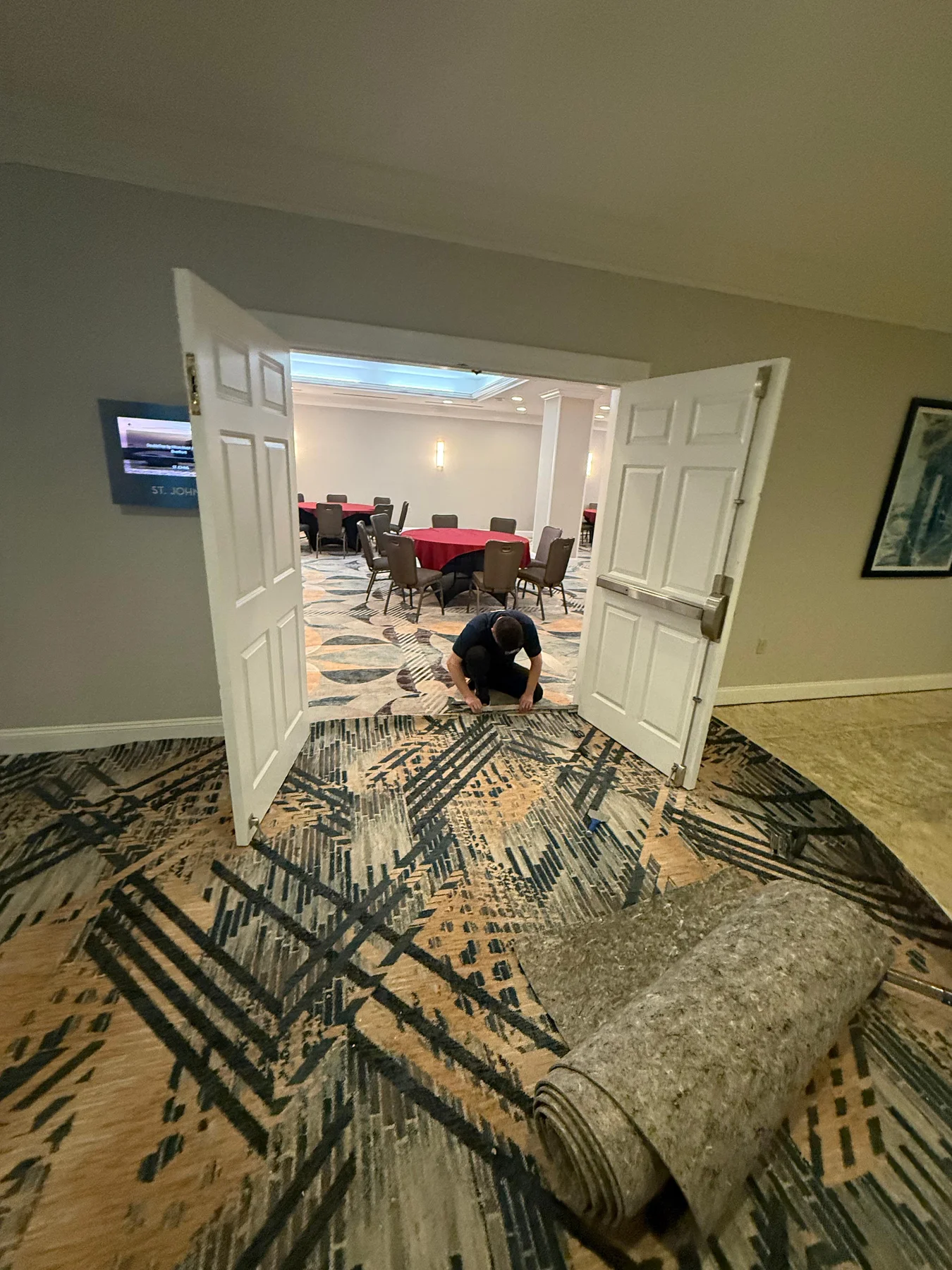 Fitting the new corridor carpet at a meeting-room doorway at DoubleTree by Hilton, Jacksonville