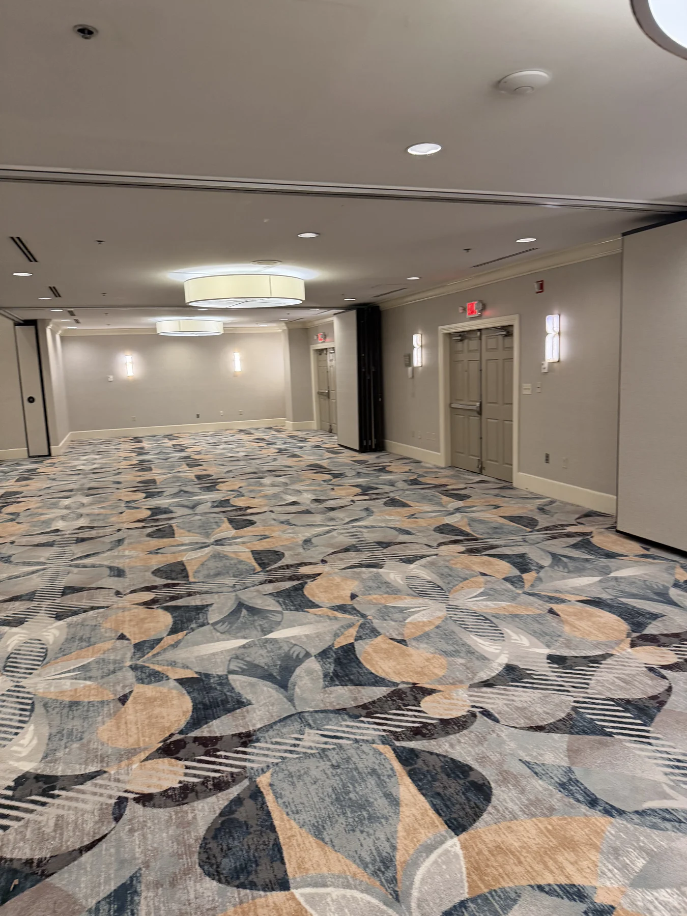 Installed patterned carpet extending through a partitioned section of the DoubleTree by Hilton ballroom