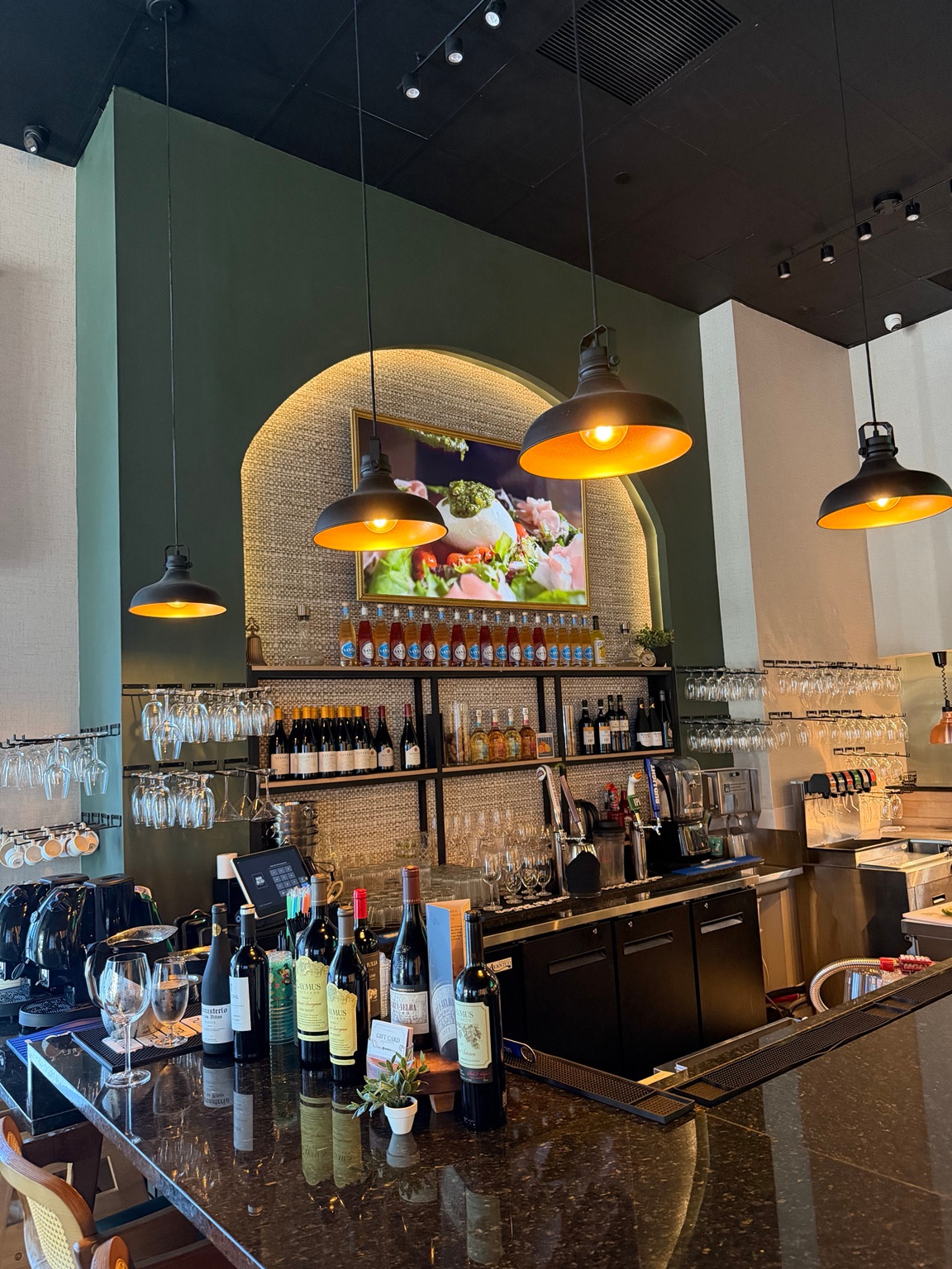 Finished feature bar with an illuminated green arch at Dom Helio Restaurant