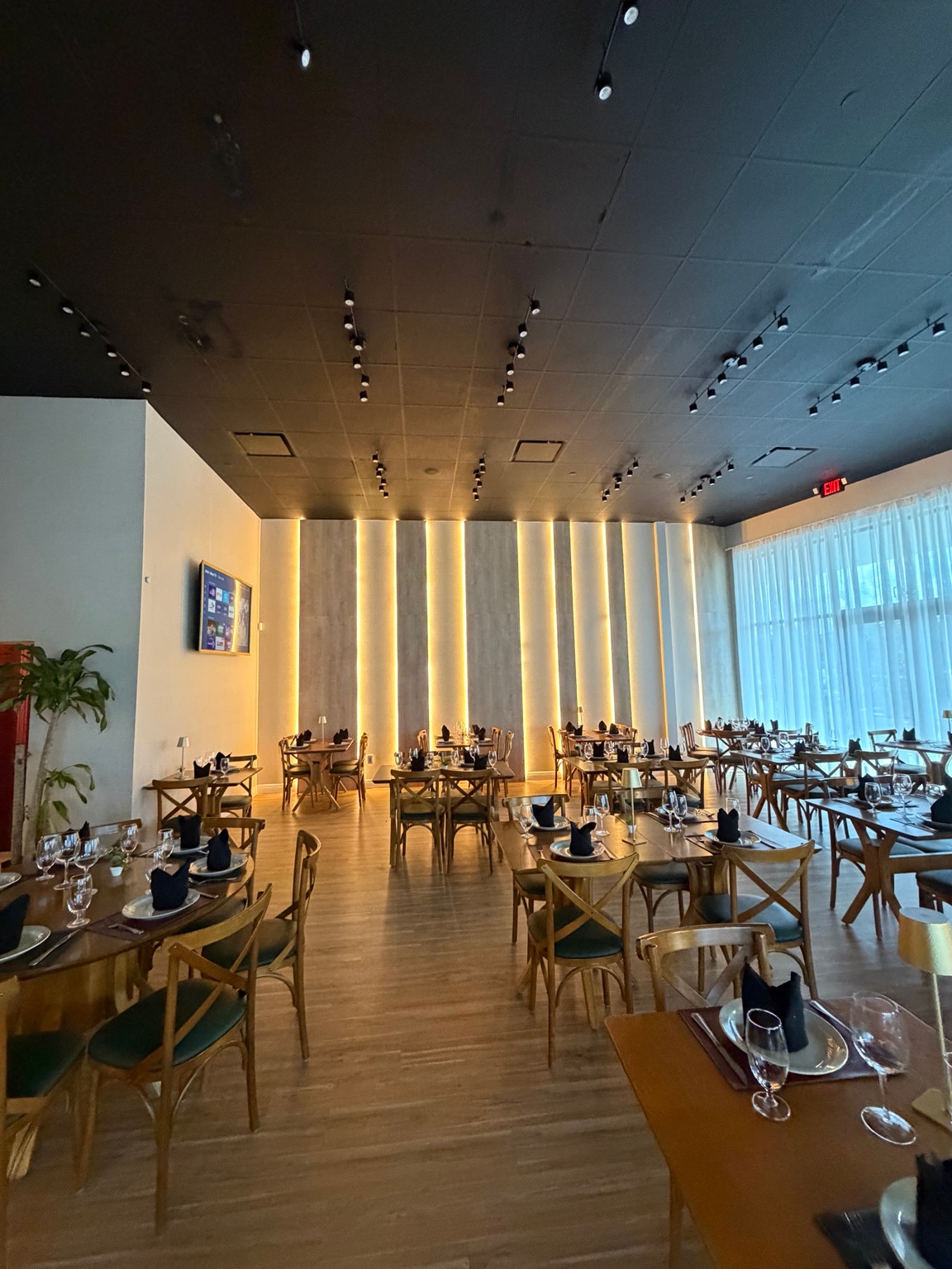 Furnished dining area with an illuminated feature wall